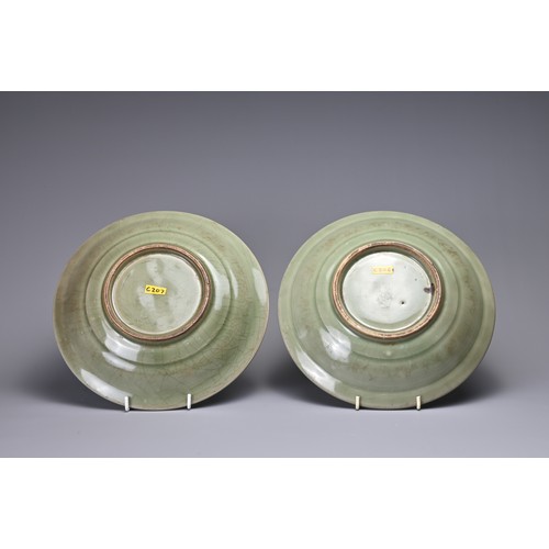 19 - TWO CHINESE LONGQUAN CELADON 'TWIN FISH' DISHES. Each thickly potted with shallow rounded sides and ... 