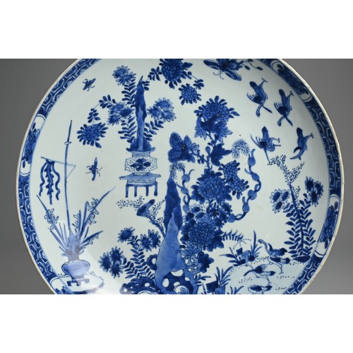 72 - A LARGE CHINESE BLUE AND WHITE PORCELAIN DISH, 18TH CENTURY. With rounded sides decorated with rockw... 