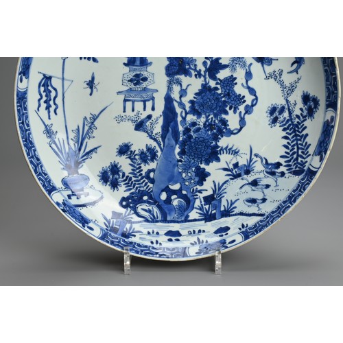 72 - A LARGE CHINESE BLUE AND WHITE PORCELAIN DISH, 18TH CENTURY. With rounded sides decorated with rockw... 