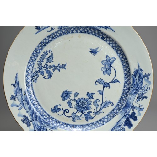 73 - A LARGE CHINESE BLUE AND WHITE PORCELAIN DISH, 18TH CENTURY. Decorated with floral sprays, a bird an... 