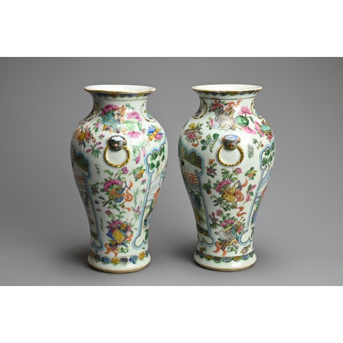 53 - A PAIR OF CHINESE FAMILLE ROSE PORCELAIN VASES, 19TH CENTURY. Of baluster form with lion ring mask r... 