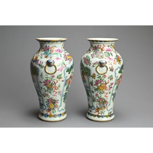 53 - A PAIR OF CHINESE FAMILLE ROSE PORCELAIN VASES, 19TH CENTURY. Of baluster form with lion ring mask r... 