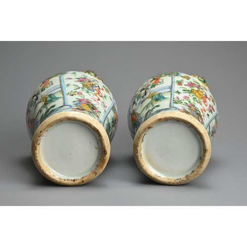 53 - A PAIR OF CHINESE FAMILLE ROSE PORCELAIN VASES, 19TH CENTURY. Of baluster form with lion ring mask r... 