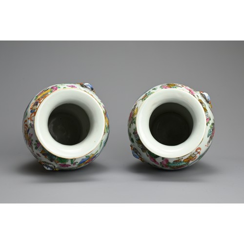 53 - A PAIR OF CHINESE FAMILLE ROSE PORCELAIN VASES, 19TH CENTURY. Of baluster form with lion ring mask r... 