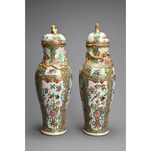 54 - A PAIR OF CHINESE CANTON FAMILLE ROSE PORCELAIN VASES AND COVERS, 19/20TH CENTURY. Of baluster form ... 