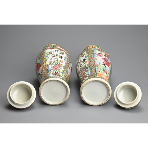 54 - A PAIR OF CHINESE CANTON FAMILLE ROSE PORCELAIN VASES AND COVERS, 19/20TH CENTURY. Of baluster form ... 