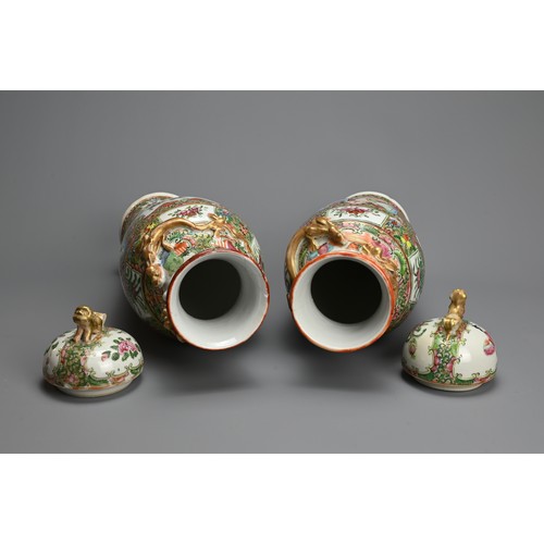 54 - A PAIR OF CHINESE CANTON FAMILLE ROSE PORCELAIN VASES AND COVERS, 19/20TH CENTURY. Of baluster form ... 