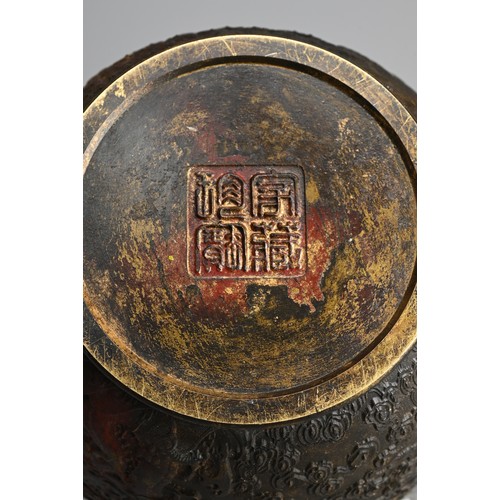 76 - A CHINESE PARCEL GILT AND RED LACQUERED JAR. Decorated to the exterior in relief with dragons chasin... 