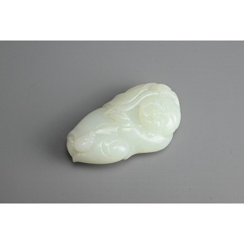 79 - A CHINESE PALE CELADON JADE FIGURE OF A BOY HOLDING A LINGZHI SPRAY. The pendant with pierced hole a... 