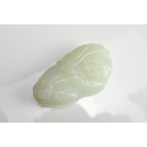 79 - A CHINESE PALE CELADON JADE FIGURE OF A BOY HOLDING A LINGZHI SPRAY. The pendant with pierced hole a... 