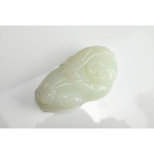 79 - A CHINESE PALE CELADON JADE FIGURE OF A BOY HOLDING A LINGZHI SPRAY. The pendant with pierced hole a... 