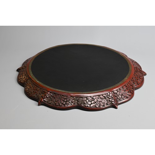 86 - A CHINESE RED LACQUER DRAGON DISH, 20TH CENTURY. With bracket lobed rim finely carved in relief with... 