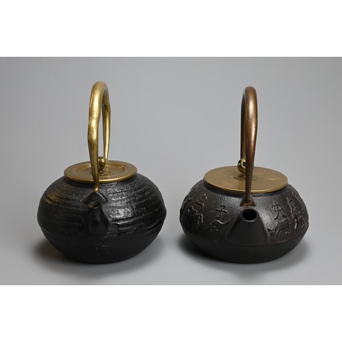 87 - TWO JAPANESE CAST IRON TEAPOTS WITH BRONZE HANDLES, 20TH CENTURY. One decorated in relief with the t... 