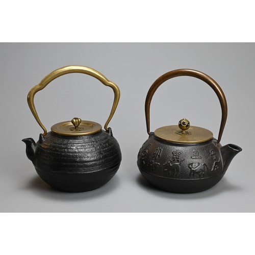 87 - TWO JAPANESE CAST IRON TEAPOTS WITH BRONZE HANDLES, 20TH CENTURY. One decorated in relief with the t... 