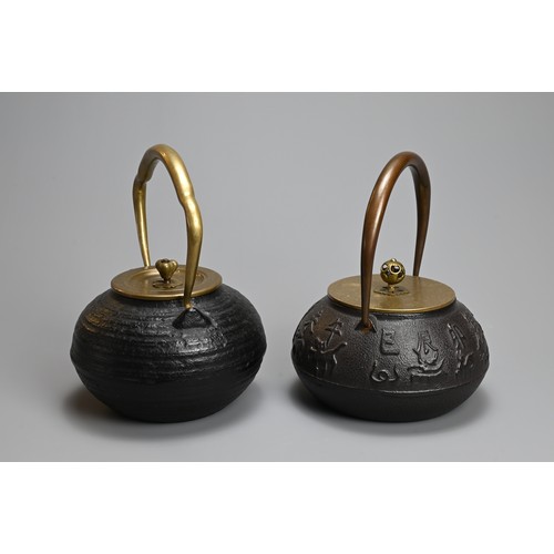 87 - TWO JAPANESE CAST IRON TEAPOTS WITH BRONZE HANDLES, 20TH CENTURY. One decorated in relief with the t... 