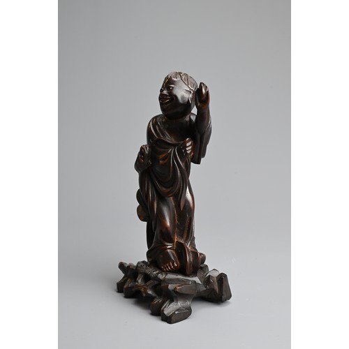 89 - A CHINESE BOXWOOD FIGURE OF LIU HAICHAN, 20TH CENTURY. The immortal standing dressed in robes with t... 