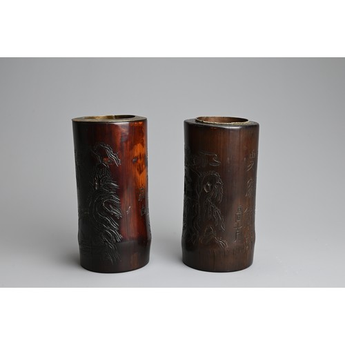 91 - TWO CHINESE METAL LINED BAMBOO BRUSH POTS, 20TH CENTURY. Each of cylindrical form carved with landsc... 