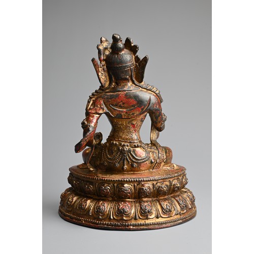 94 - A CHINESE RED LACQUERED AND GILT BRONZE FIGURE OF TARA. Seated on lotus base holding ritual items. 1... 