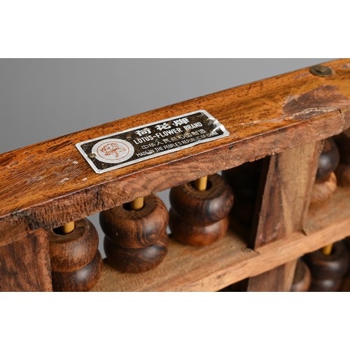 95 - TWO CHINESE HARDWOOD ABACUS, EARLY 20TH CENTURY. One with metal plaque from Lotus Flower Brand, made... 