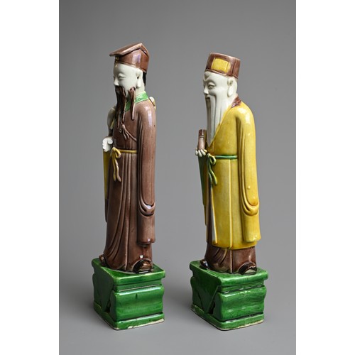 9 - TWO CHINESE SANCAI GLAZED PORCELAIN FIGURES OF SAGES, 19/20TH CENTURY. Each standing dressed in robe... 