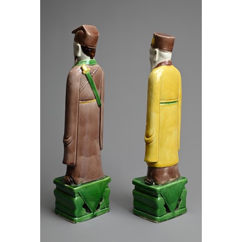 9 - TWO CHINESE SANCAI GLAZED PORCELAIN FIGURES OF SAGES, 19/20TH CENTURY. Each standing dressed in robe... 