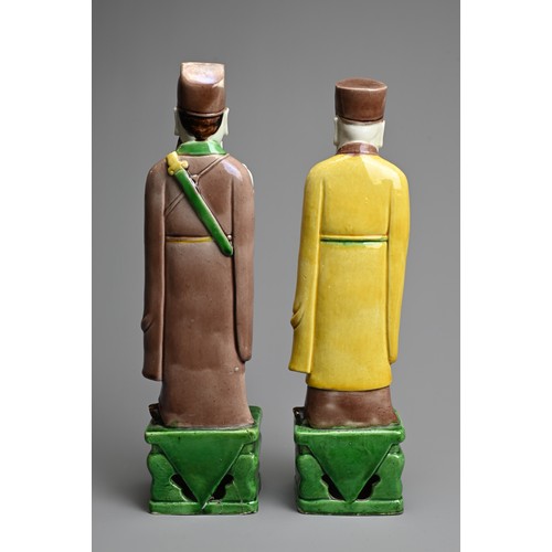 9 - TWO CHINESE SANCAI GLAZED PORCELAIN FIGURES OF SAGES, 19/20TH CENTURY. Each standing dressed in robe... 