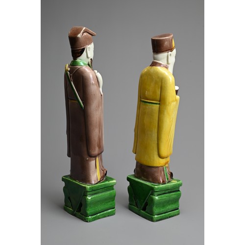 9 - TWO CHINESE SANCAI GLAZED PORCELAIN FIGURES OF SAGES, 19/20TH CENTURY. Each standing dressed in robe... 