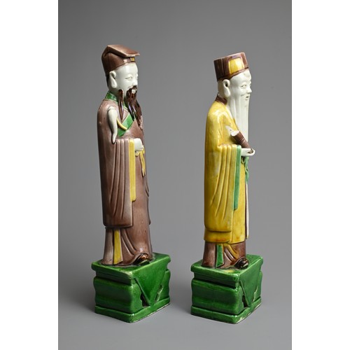 9 - TWO CHINESE SANCAI GLAZED PORCELAIN FIGURES OF SAGES, 19/20TH CENTURY. Each standing dressed in robe... 