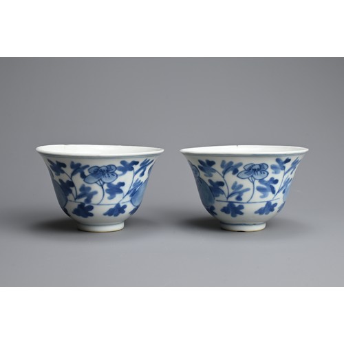 4 - A PAIR OF CHINESE BLUE AND WHITE PORCELAIN CUPS, 19/20TH CENTURY. Of bell form decorated with peony ... 