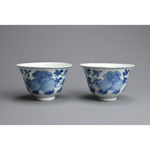 4 - A PAIR OF CHINESE BLUE AND WHITE PORCELAIN CUPS, 19/20TH CENTURY. Of bell form decorated with peony ... 