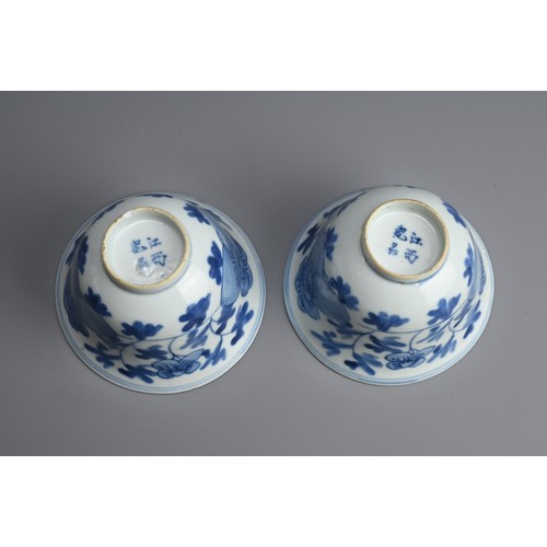 4 - A PAIR OF CHINESE BLUE AND WHITE PORCELAIN CUPS, 19/20TH CENTURY. Of bell form decorated with peony ... 