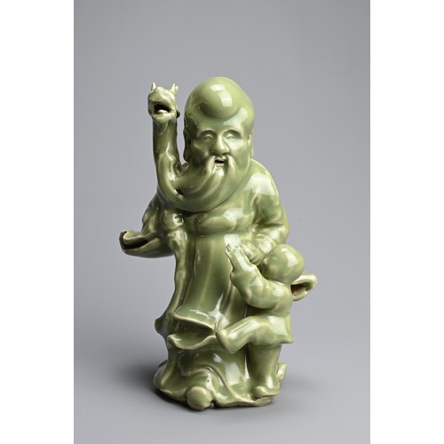 20 - A CHINESE MING STYLE LONGQUAN CELADON GLAZED PORCELAIN FIGURE OF SHOULAO. The figure dressed in bill... 