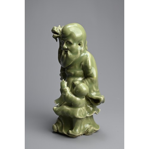 20 - A CHINESE MING STYLE LONGQUAN CELADON GLAZED PORCELAIN FIGURE OF SHOULAO. The figure dressed in bill... 