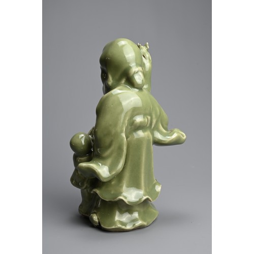 20 - A CHINESE MING STYLE LONGQUAN CELADON GLAZED PORCELAIN FIGURE OF SHOULAO. The figure dressed in bill... 