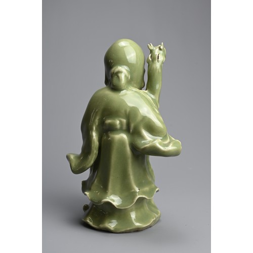 20 - A CHINESE MING STYLE LONGQUAN CELADON GLAZED PORCELAIN FIGURE OF SHOULAO. The figure dressed in bill... 