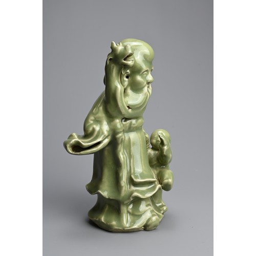 20 - A CHINESE MING STYLE LONGQUAN CELADON GLAZED PORCELAIN FIGURE OF SHOULAO. The figure dressed in bill... 