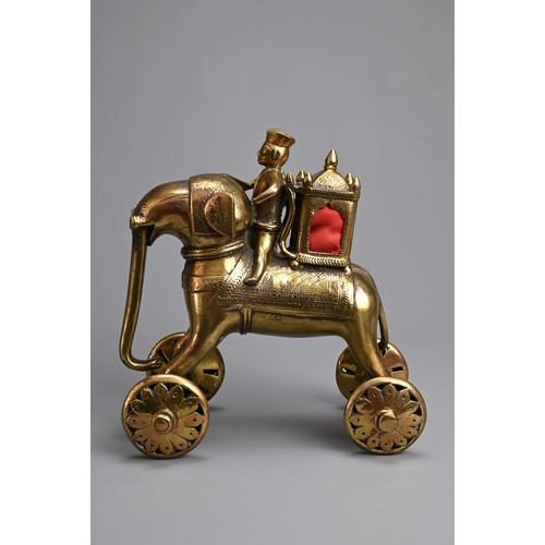 97 - AN INDIAN BRONZE TEMPLE TOY MODEL OF AN ELEPHANT AND RIDER WITH HOWDAH. Standing four square with wh... 