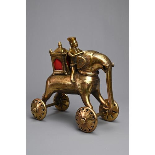 97 - AN INDIAN BRONZE TEMPLE TOY MODEL OF AN ELEPHANT AND RIDER WITH HOWDAH. Standing four square with wh... 