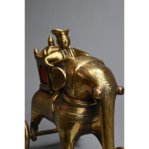 97 - AN INDIAN BRONZE TEMPLE TOY MODEL OF AN ELEPHANT AND RIDER WITH HOWDAH. Standing four square with wh... 