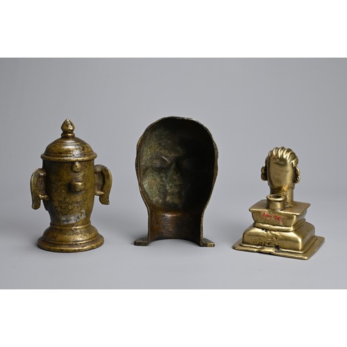 99 - THREE INDIAN BRASS / BRONZE HEADS OF SHIVA AND GAURI. The icons front facing on raised pedestals. 10... 