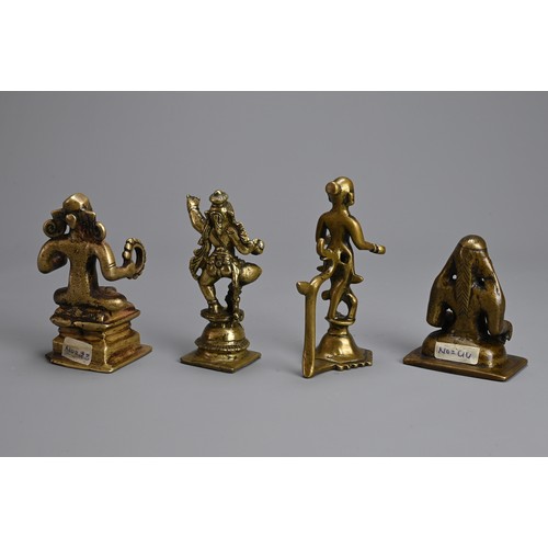 106 - A GROUP OF INDIAN BRONZE BRASS IDOLS OF HINDU DEITIES. Of various forms. 7cm - 11cm tall. (4)