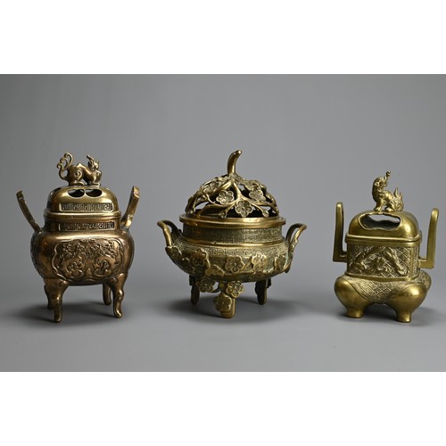 30 - THREE CHINESE POLISHED BRONZE INCENSE BURNERS WITH COVERS, 20TH CENTURY. Of various forms with pierc... 