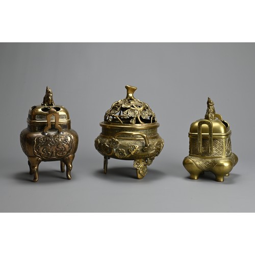 30 - THREE CHINESE POLISHED BRONZE INCENSE BURNERS WITH COVERS, 20TH CENTURY. Of various forms with pierc... 