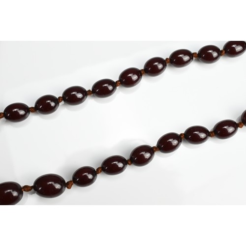 33 - A SINGLE STRAND CHERRY AMBER BEADED NECKLACE. With 36 graduating beads, strung and knotted (no clasp... 