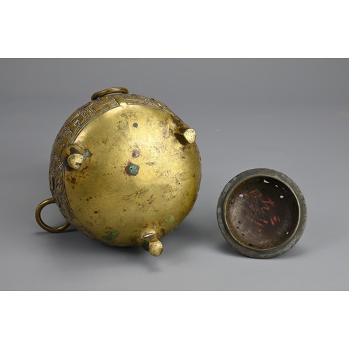 35 - A CHINESE BRONZE TRIPOD JAR AND COVER, 18/19TH CENTURY. Globular body supported on three feet with p... 