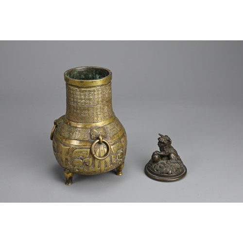 35 - A CHINESE BRONZE TRIPOD JAR AND COVER, 18/19TH CENTURY. Globular body supported on three feet with p... 