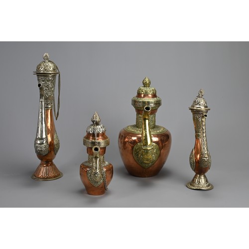 38 - A GROUP OF FOUR TIBETAN MIXED METAL EWERS, 19/20TH CENTURY. Of various forms with zoomorphic handles... 