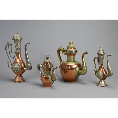 38 - A GROUP OF FOUR TIBETAN MIXED METAL EWERS, 19/20TH CENTURY. Of various forms with zoomorphic handles... 