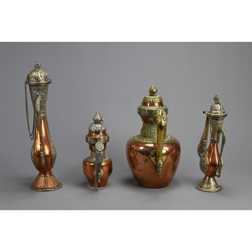 38 - A GROUP OF FOUR TIBETAN MIXED METAL EWERS, 19/20TH CENTURY. Of various forms with zoomorphic handles... 