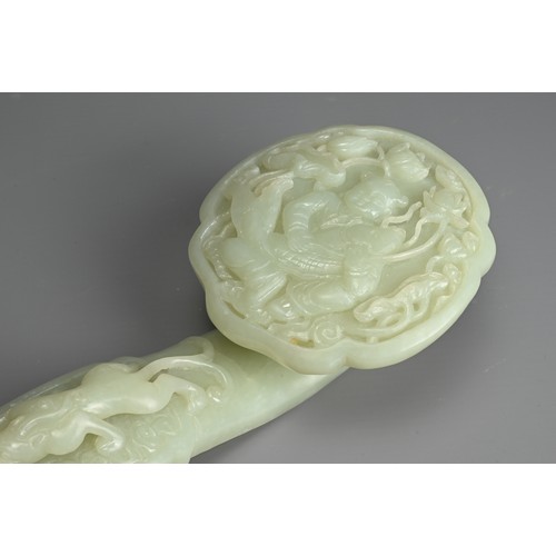 40 - A CHINESE JADE RUYI SCEPTRE WITH MIRROR AND CORAL FIGURE. The ruyi sceptre carved in relief with boy... 